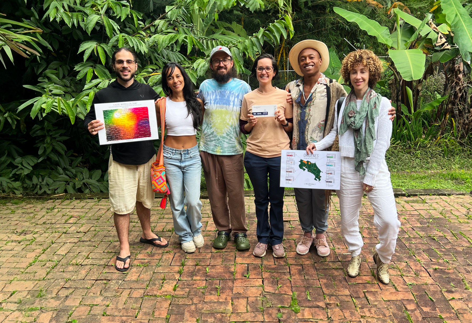 Guests on the farm tour holding heirloom cacao tasting charts